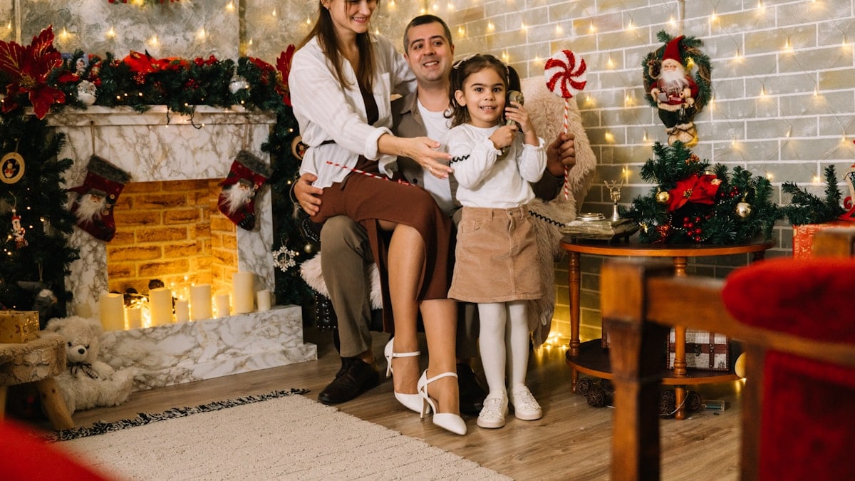 A family posing for a picture in front of a christmas tree